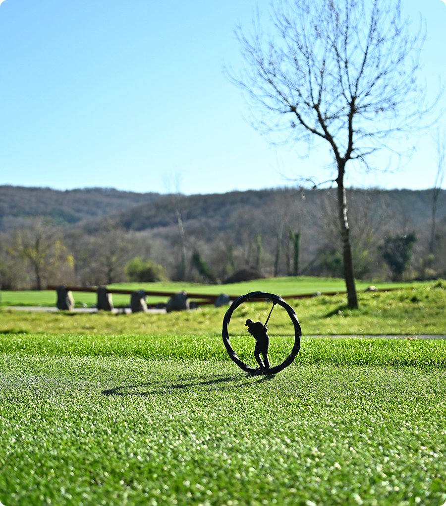 Close up of golf ball with golfer in background